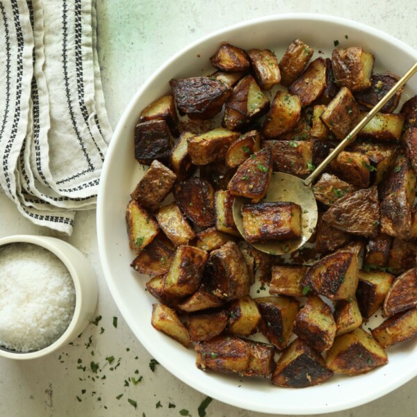 truffle potatoes in a white serving dish