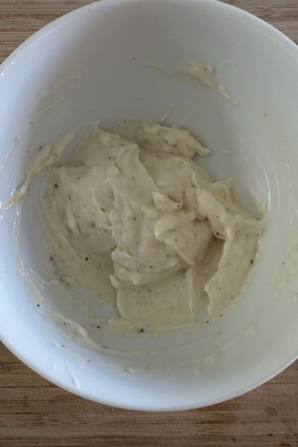 a white bowl filled with garlic chive aioli 