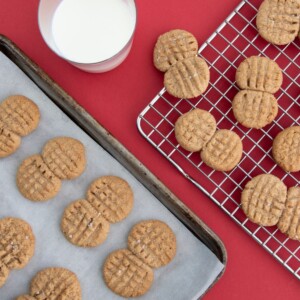 Overhead view of homemade Nutter Butter cookies with flaky salt on top, showing signature peanut shape
