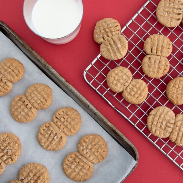 Overhead view of homemade Nutter Butter cookies with flaky salt on top, showing signature peanut shape
