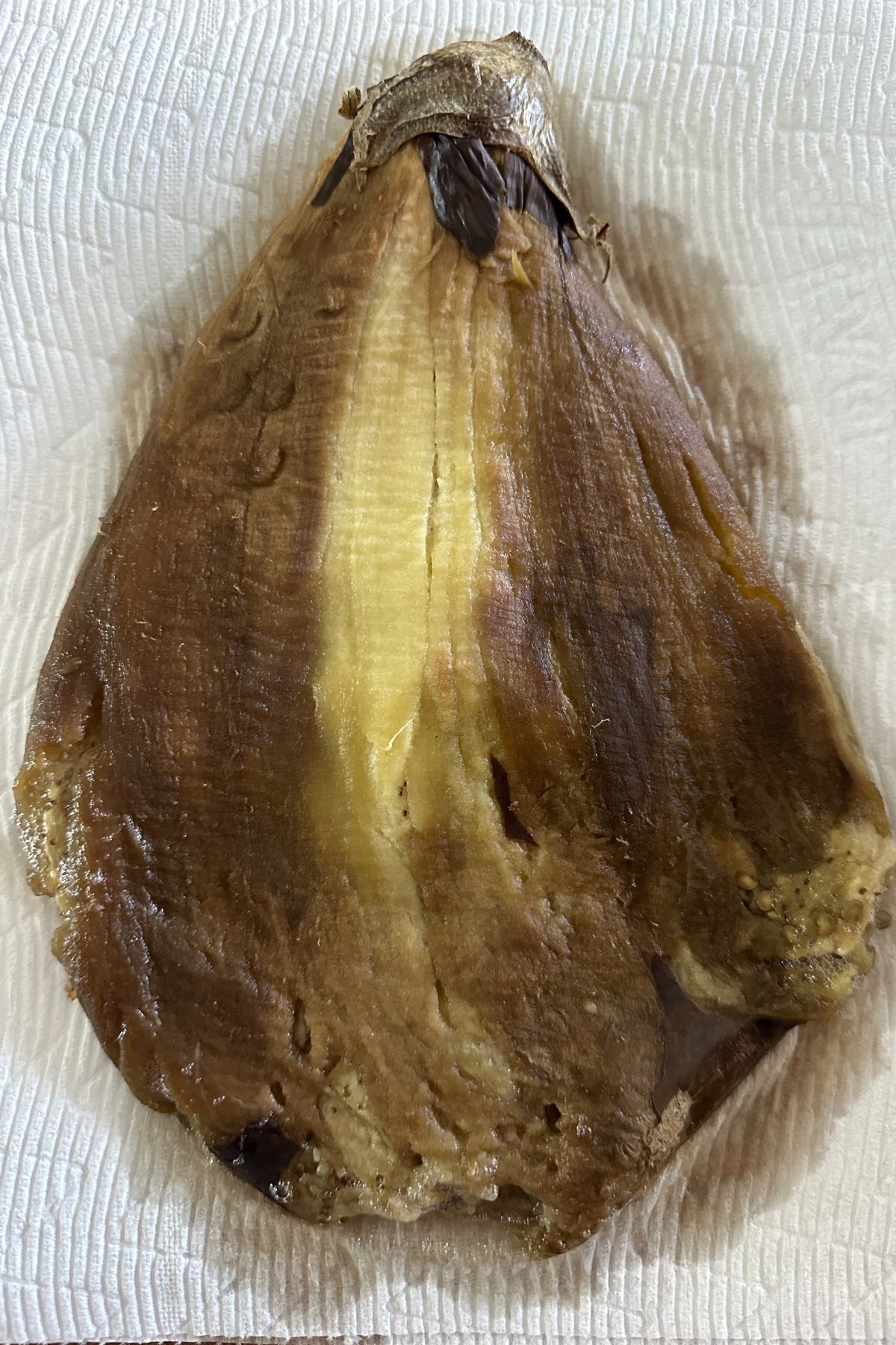 Peeled roasted eggplant flattened into cutlet shape with stem intact