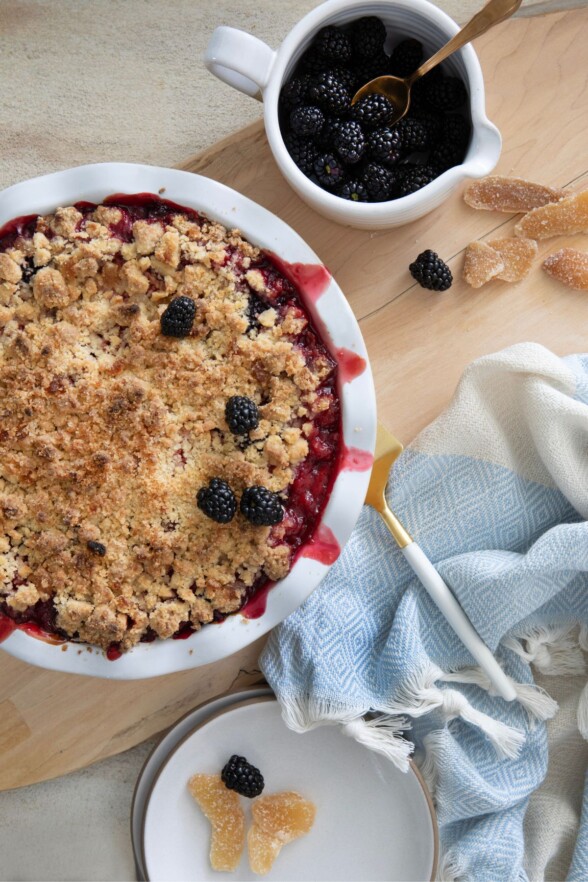 Mixed berry crumble pie right out of the oven, edges bubbling and topping golden brown
