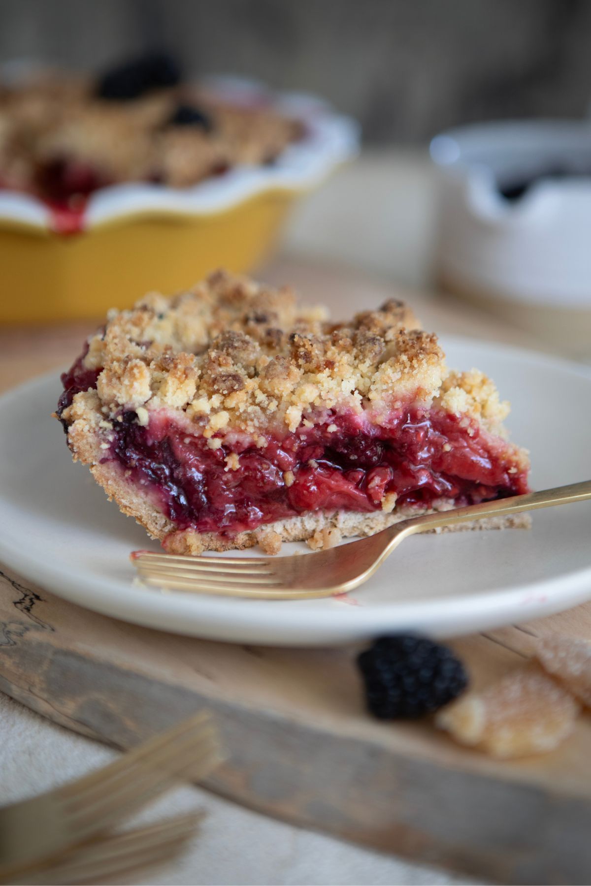 Single slice of mixed berry crumble pie plated