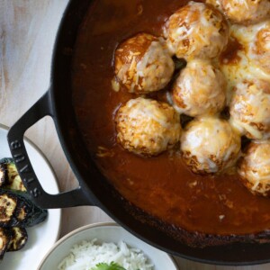 tex mex meatballs in a pan with enchilada sauce