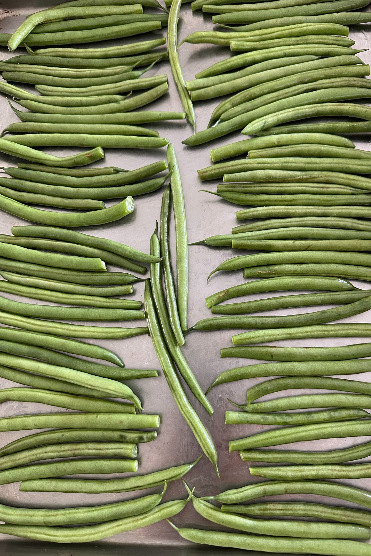 trimmed green beans on a baking sheet