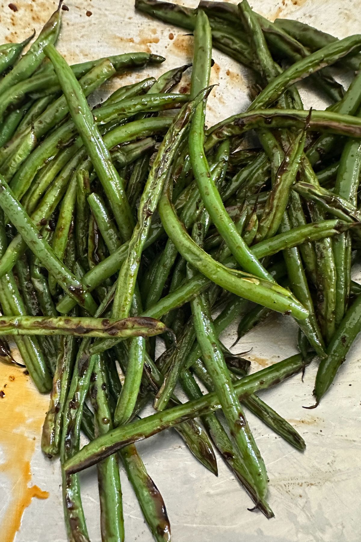 blistered green beans tossed in sauce and ready to serve 