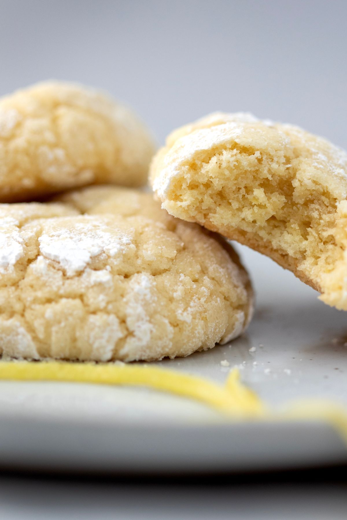 close up shot of lemon crinkle cookies with powdered sugar dusting
