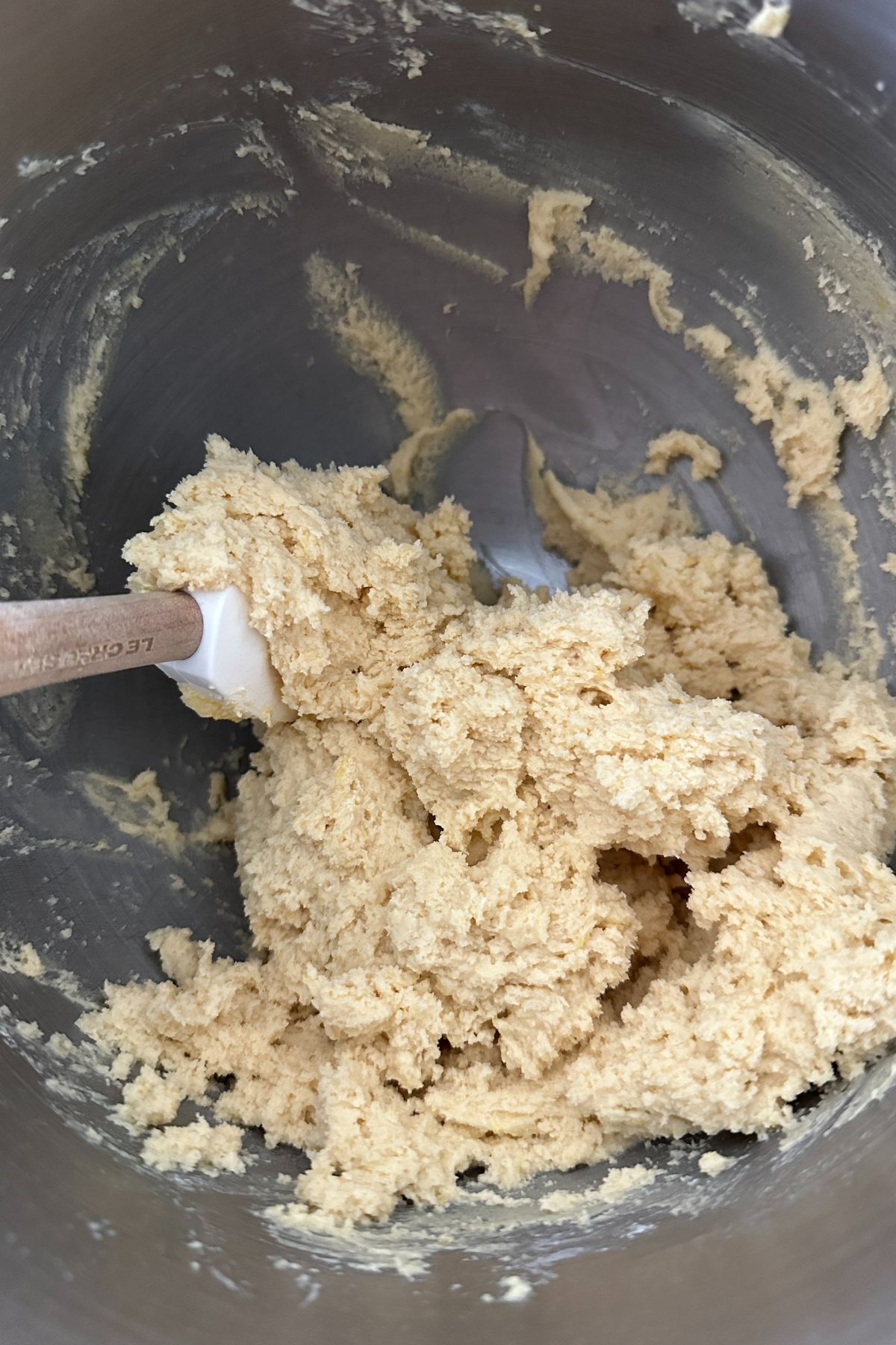 Dry ingredients like flour, baking soda, and salt being whisked together with the wet ingredients