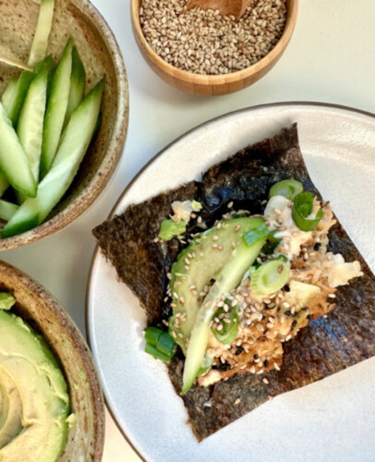 a scoop of salmon sushi bake on a sheet of nori