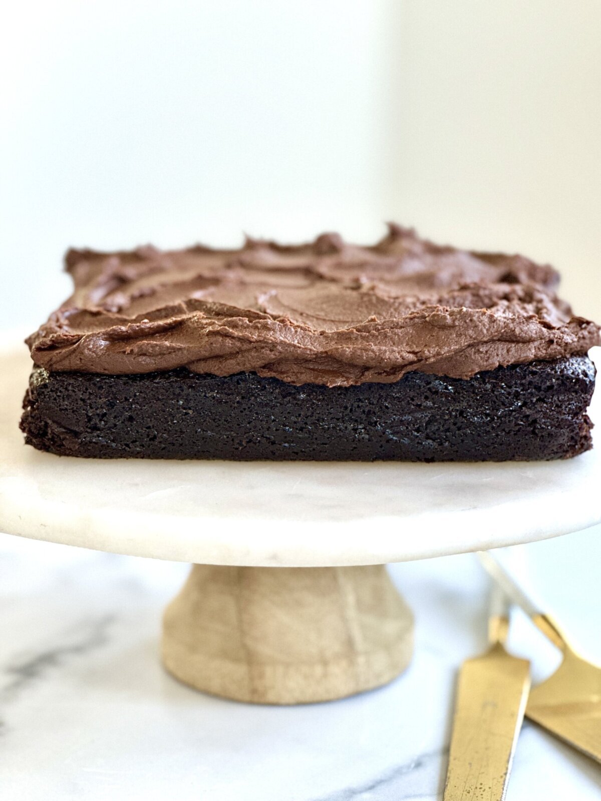 sweet potato frosting spread on top of a gluten-free vegan chocolate cake