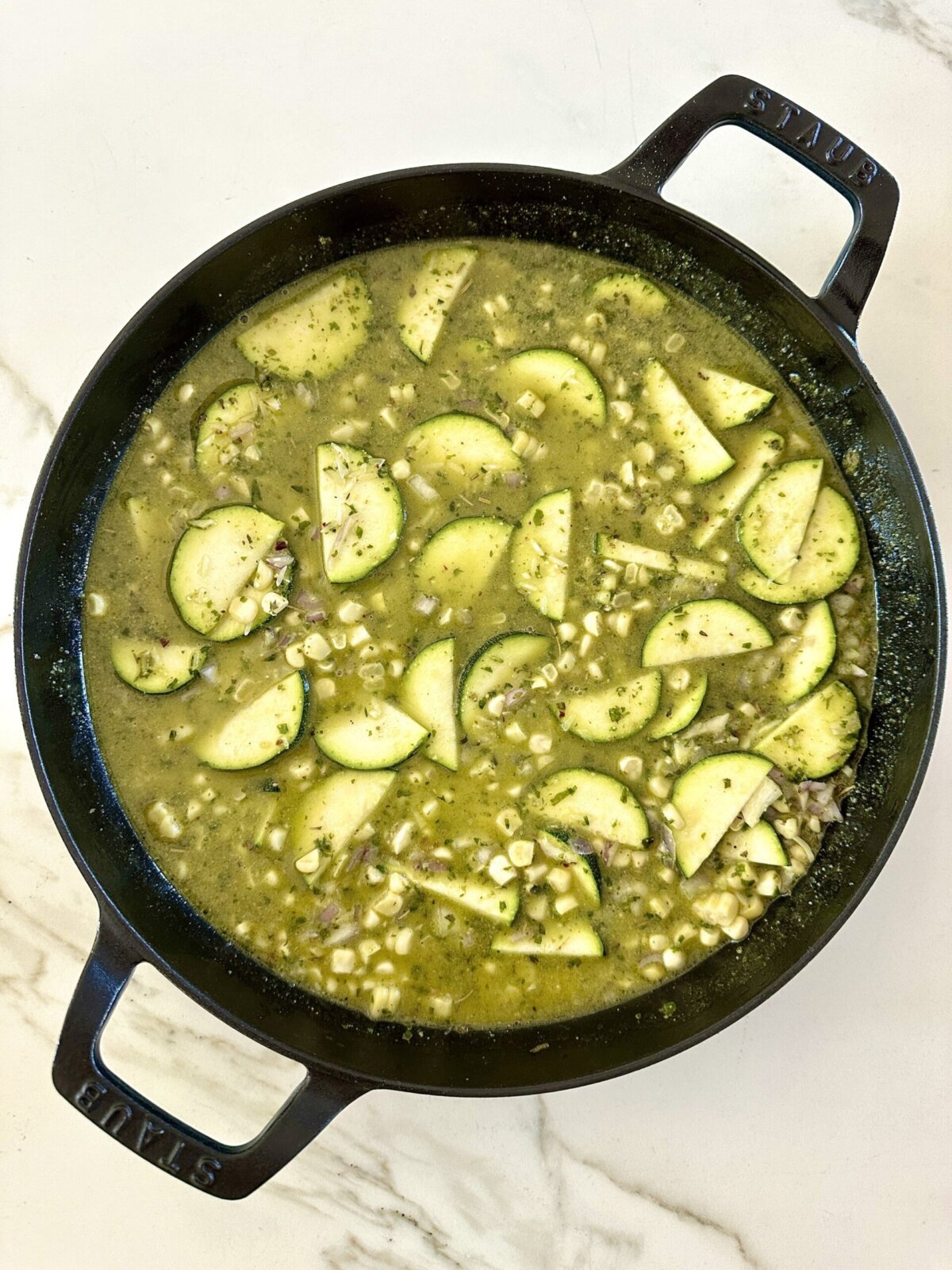 ingredients in this zucchini bake mixed in a round baking dish