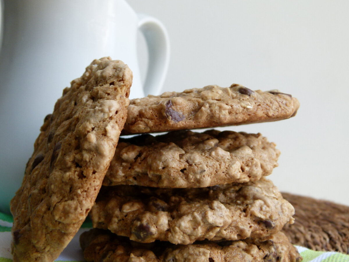 a stack of cookies next to a white mug