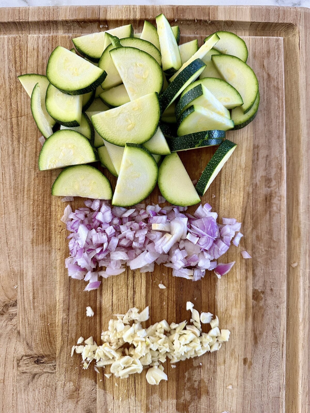 cut veggies on a wooden cutting board