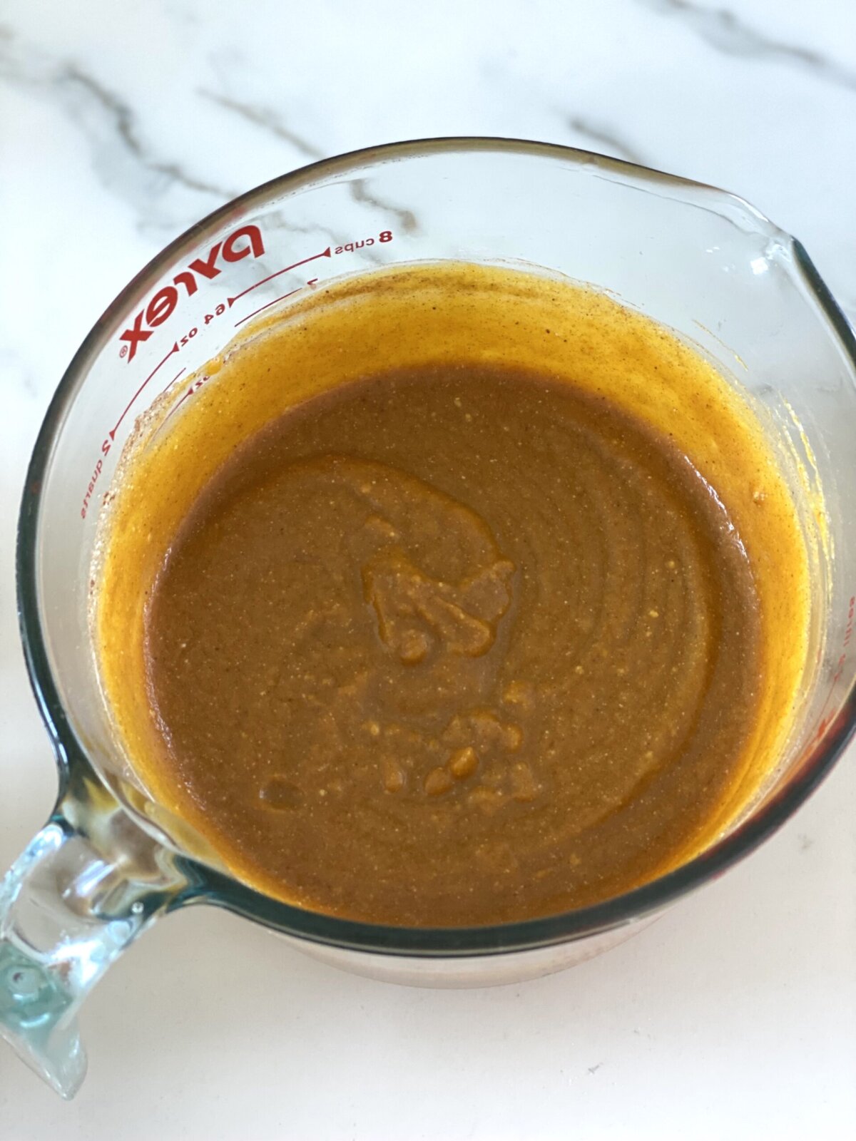 pumpkin pie filling in a glass measuring cup